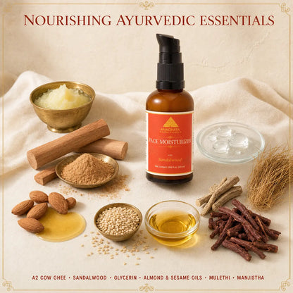 A bottle of A2 Cow Face Moisturizer with a black pump and amber glass bottle, surrounded by its natural ingredients including almonds, sandalwood, honey, sesame seeds, and oils on a beige fabric background.