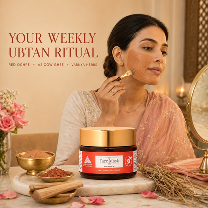 A woman applies a facial mask while a jar of Red Ochre Face Mask sits on a marble surface with skincare props, flowers, and a mirror in a warm indoor setting. Text on the image reads 'YOUR WEEKLY UBTAN RITUAL' with ingredients listed below.